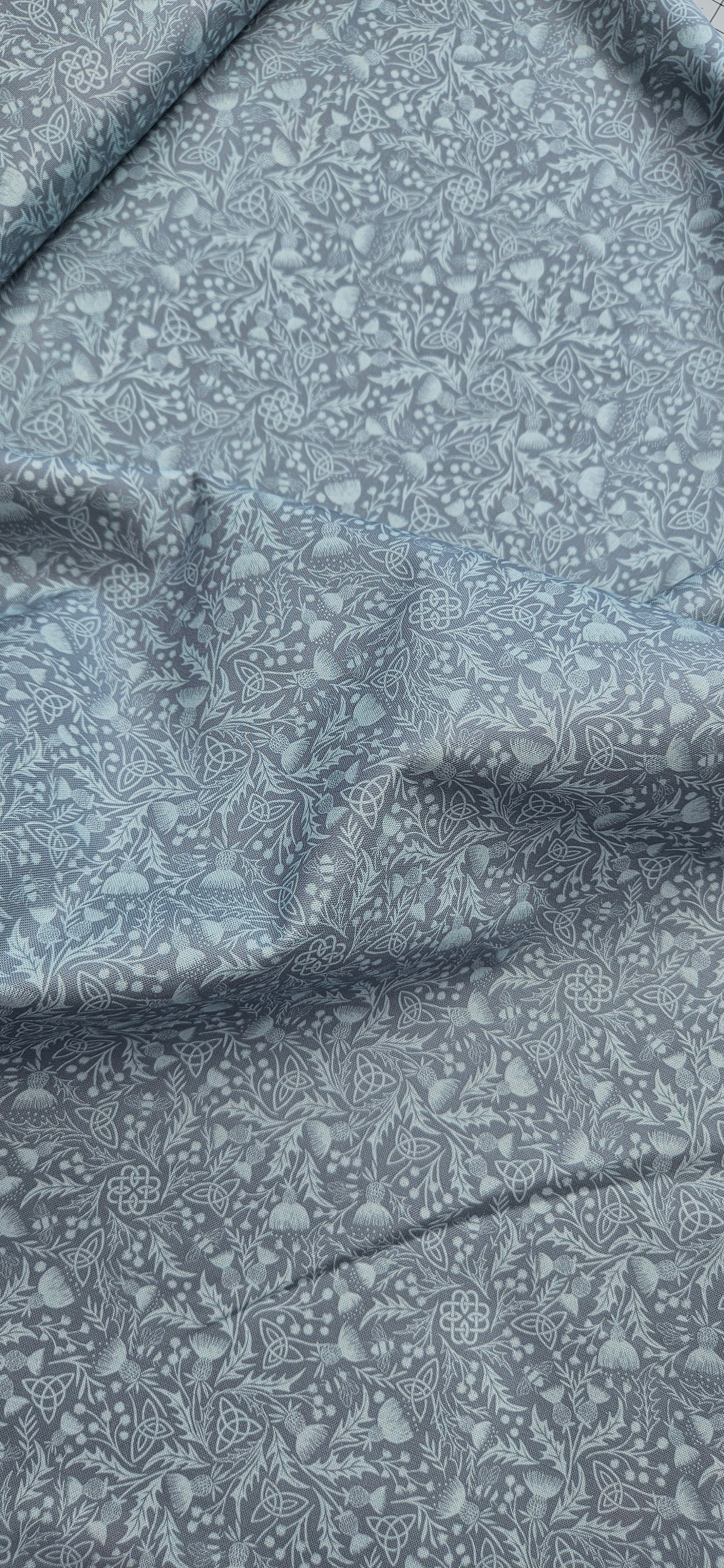 Lewis & Irene Celtic Thistle Duck Egg premium quilting cotton fabric featuring thistle motifs on a soft duck egg background.