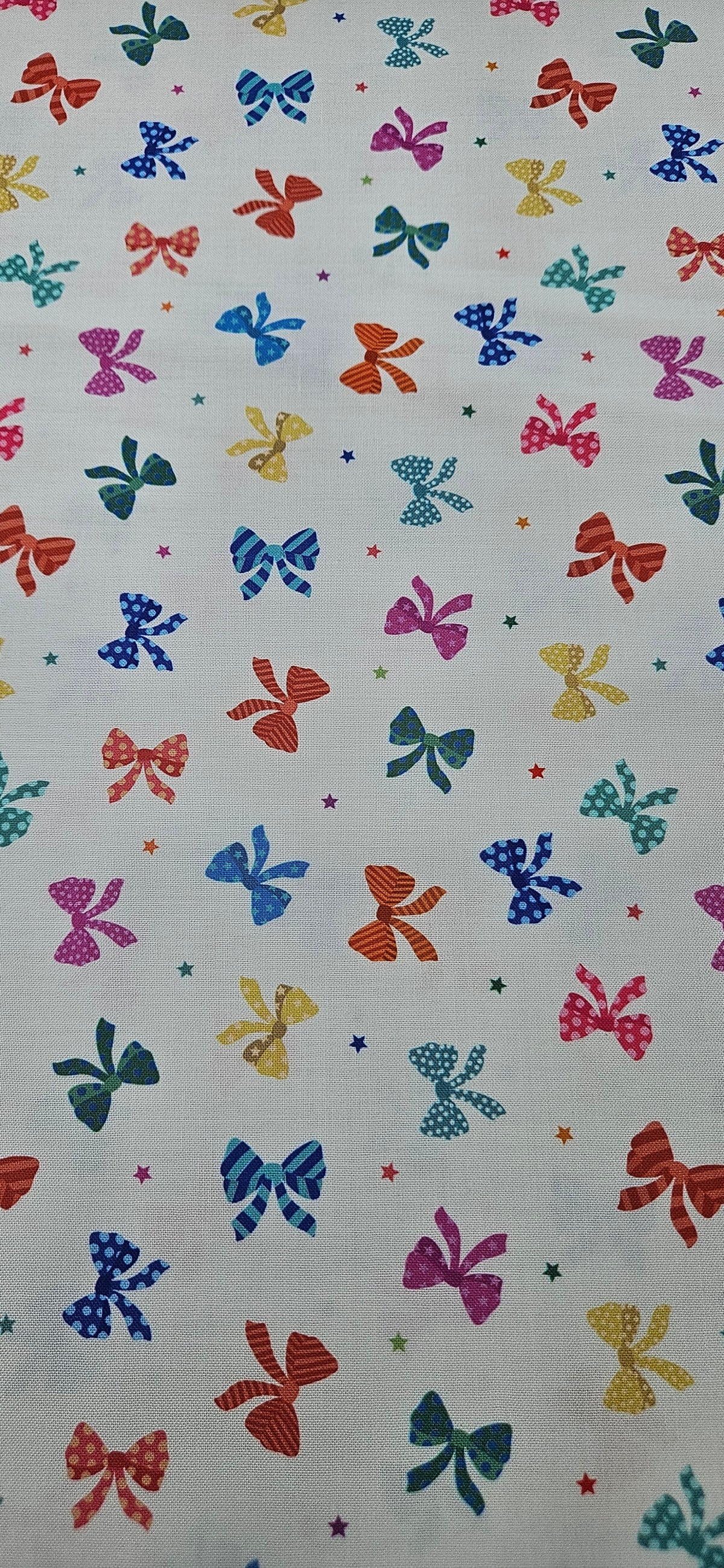 Lewis & Irene Small Things Celebrations Bows cotton fabric with colourful bows and stars on white