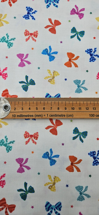 Lewis & Irene Small Things Celebrations Bows cotton fabric with colourful bows and stars on white