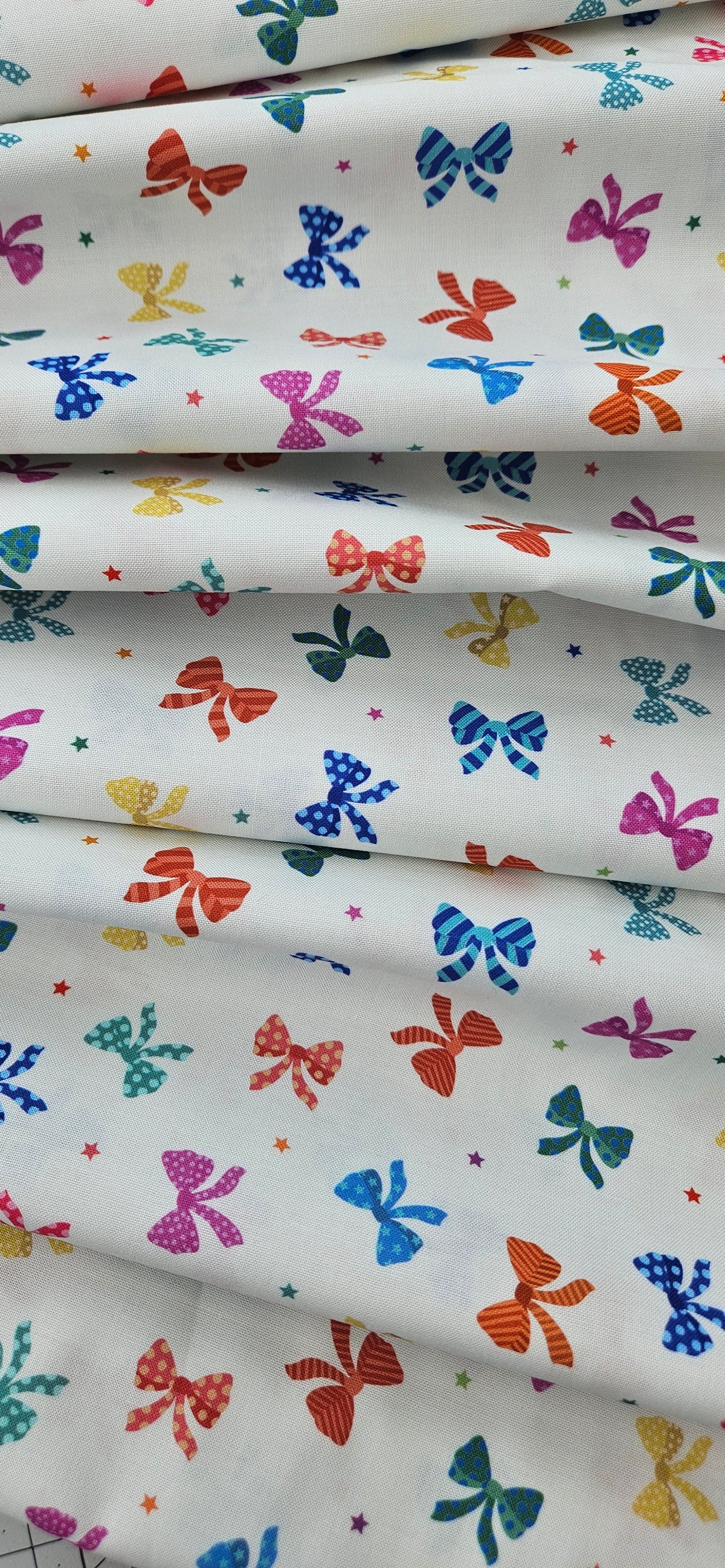 Lewis & Irene Small Things Celebrations Bows cotton fabric with colourful bows and stars on white