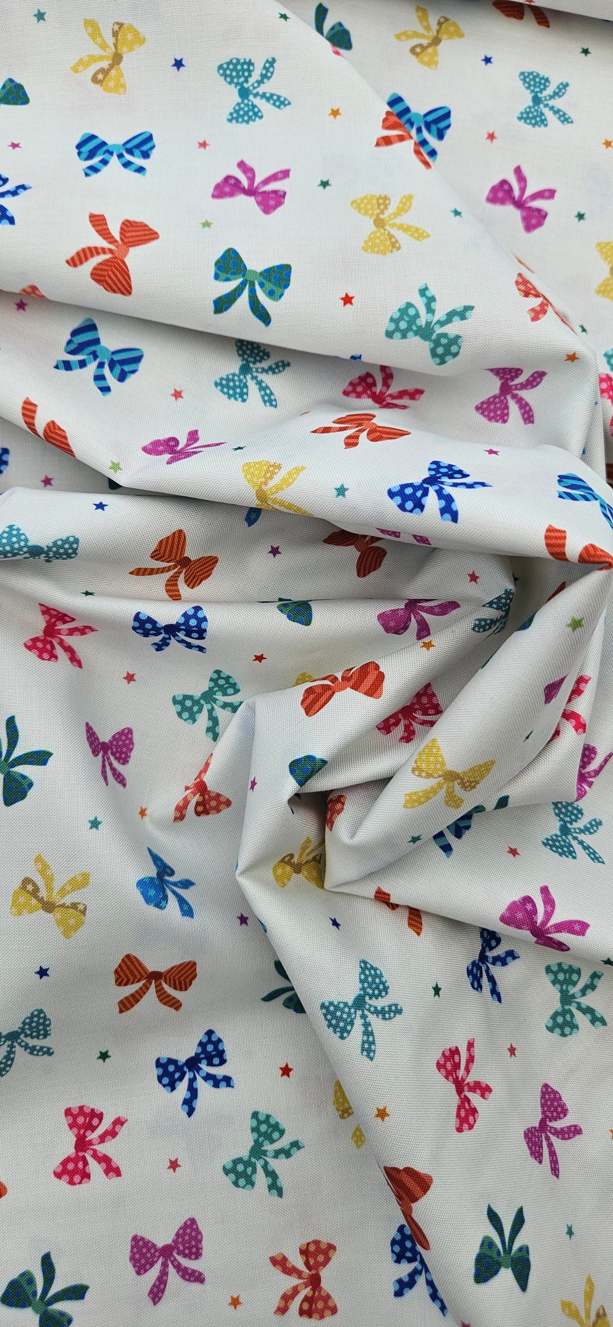 Lewis & Irene Small Things Celebrations Bows cotton fabric with colourful bows and stars on white