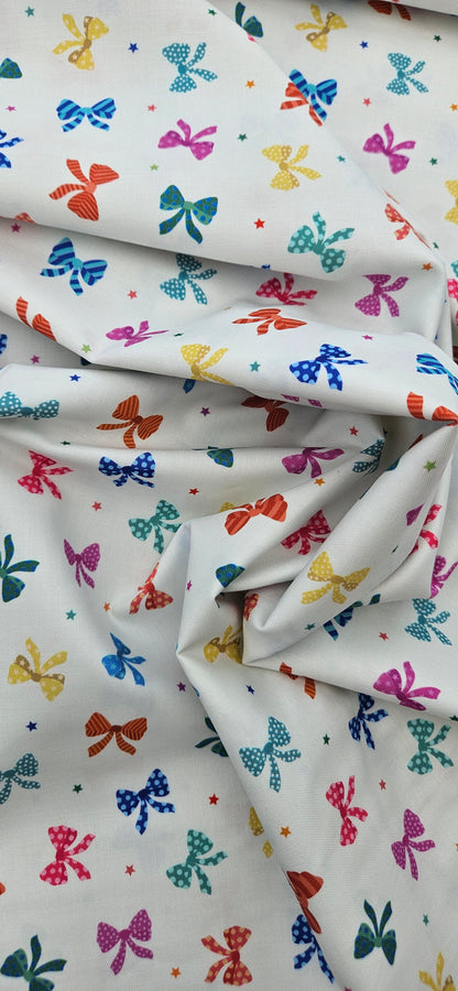 Lewis & Irene Small Things Celebrations Bows cotton fabric with colourful bows and stars on white